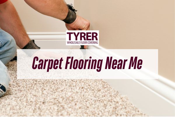 Installer laying new carpet flooring with Tyrer Wholesale Floor Covering branding and the text “Carpet Flooring Near Me