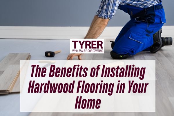 man installing hardwood flooirng with a caption The Benefits of Installing Hardwood Flooring in Your Home.jpg