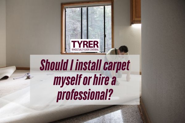 man installing a carpet with a caption Should I install carpet myself or hire a professional